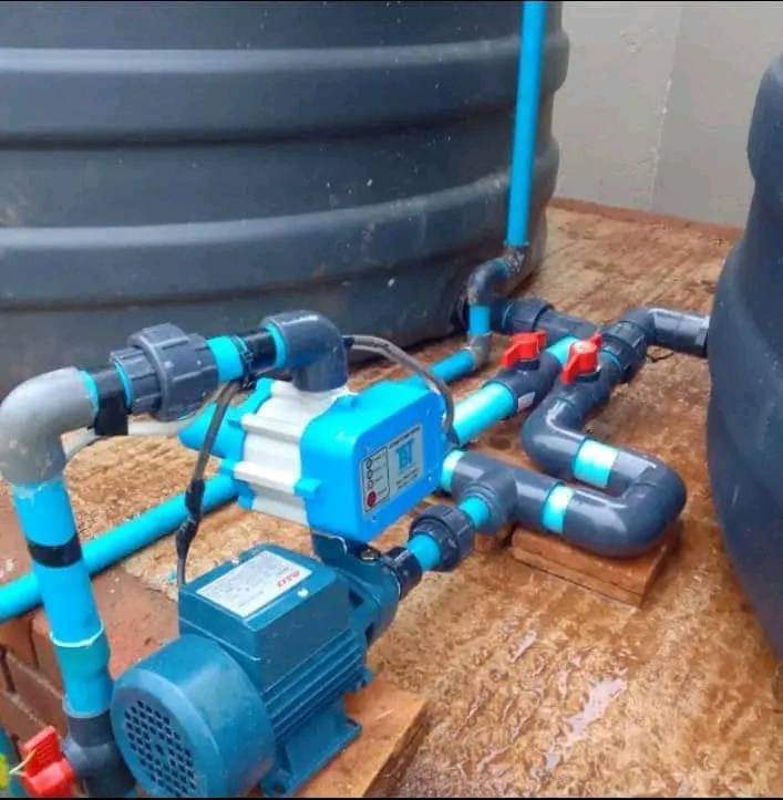 Laying water pipes in a field.